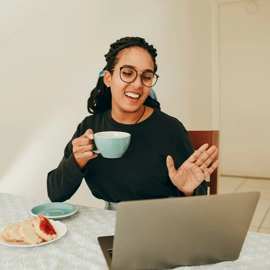 woman in black long sleeve shirt holding white ceramic mug
